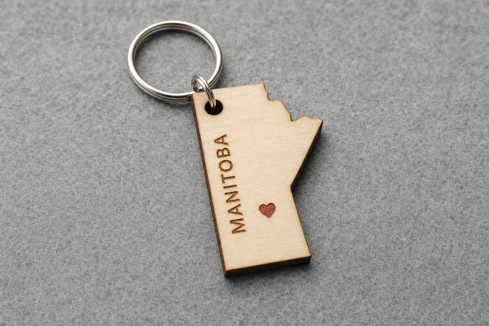 Province-shaped wooden keychain engraved Manitoba with a red heart